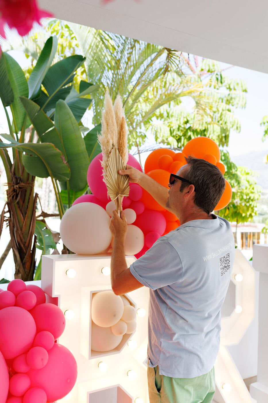 BRICHELLA marquee letters under a covered terrace with mountain views, Marbella