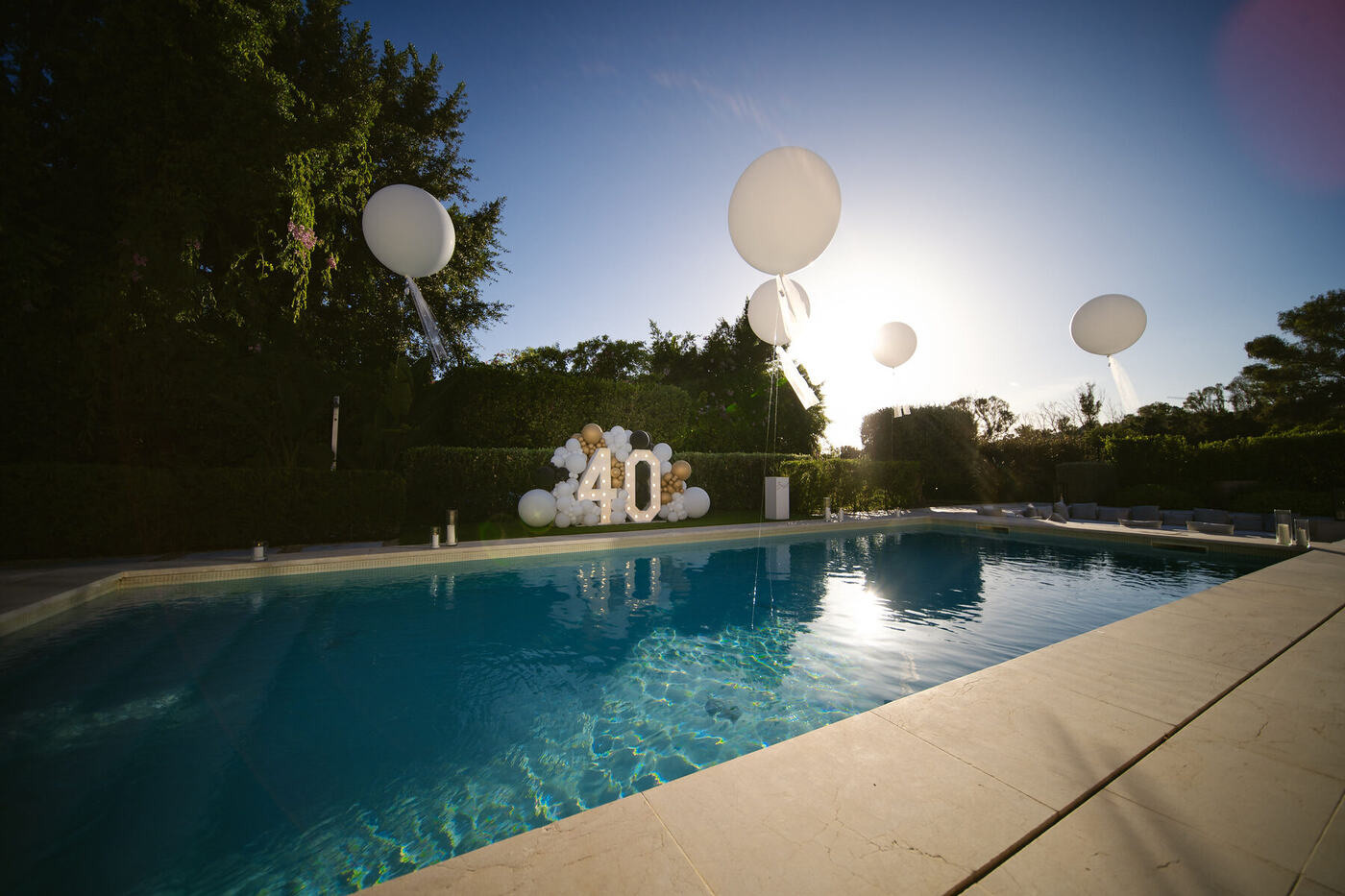 Light-up 40 numbers reflected in the pool at sunset, Marbella villa